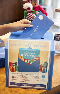Acts of Random Kindness distributed hundreds of blue envelopes containing food vouchers in Cayman this Christmas.