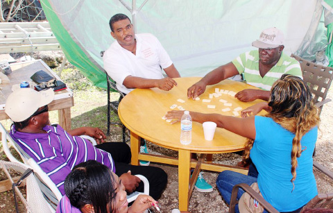 Adults enjoying a game of dominoes.