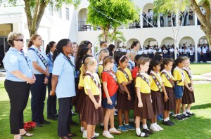 Guides and Brownies take part at a school Remembrance Day.
