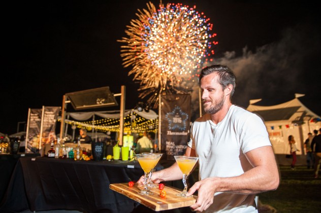 Dan Hollis, of Margaritaville, delivers some of his award-winning drinks to judges in the mixology competition as fireworks fill the air at the annual Taste of Cayman at Festival Green at Camana Bay. Mr. Hollis won the competition. - PHOTO: TANEOS RAMSAY