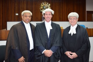 Oliver Goodwin is flanked by Cline Glidden, left, and Justice Charles Quin.