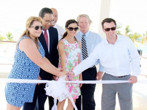 From left, Jessica Tibbetts-Buchanan, Premier Alden McLaughlin, Sister Islands District Commissioner Ernie Scott, Emily Tibbetts-Allenbach, Tourism Minister Moses Kirkconnell and Michael Tibbetts cut the ribbon on the redesigned resort. – Photo: James Whittaker