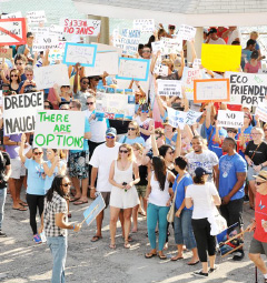 Between 250 and 300 people, many of them holding placards, protested the proposed cruise ship berthing facility at the George Town waterfront.– Photo: Alan Markoff