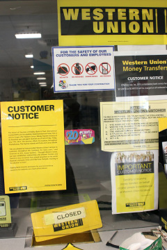 A sign outside a Western Union counter in July announces that the money transfer service would not longer be available. Services relaunched in November.