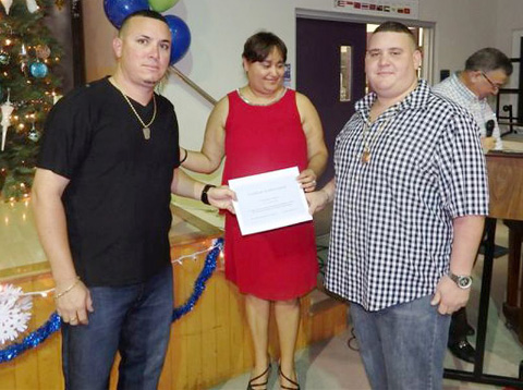 Len Smith’s sons, Matthew and Taron, collected a certificate from Jeana Ebanks on their father’s behalf.