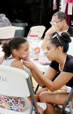 Ryne Rankine gets her face painted by Ashli Welcome.