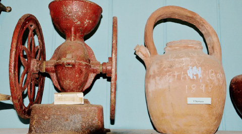 An old corn mill and clay pot, two of the many artifacts in Powell
