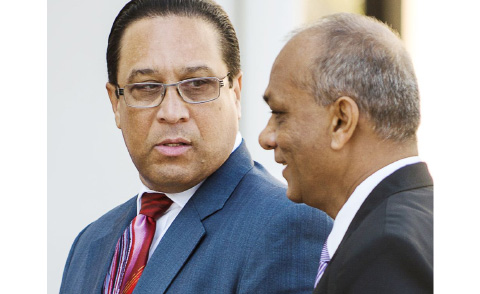 Premier Alden McLaughlin, left, is escorted by Chief Marshal Richard Harford.