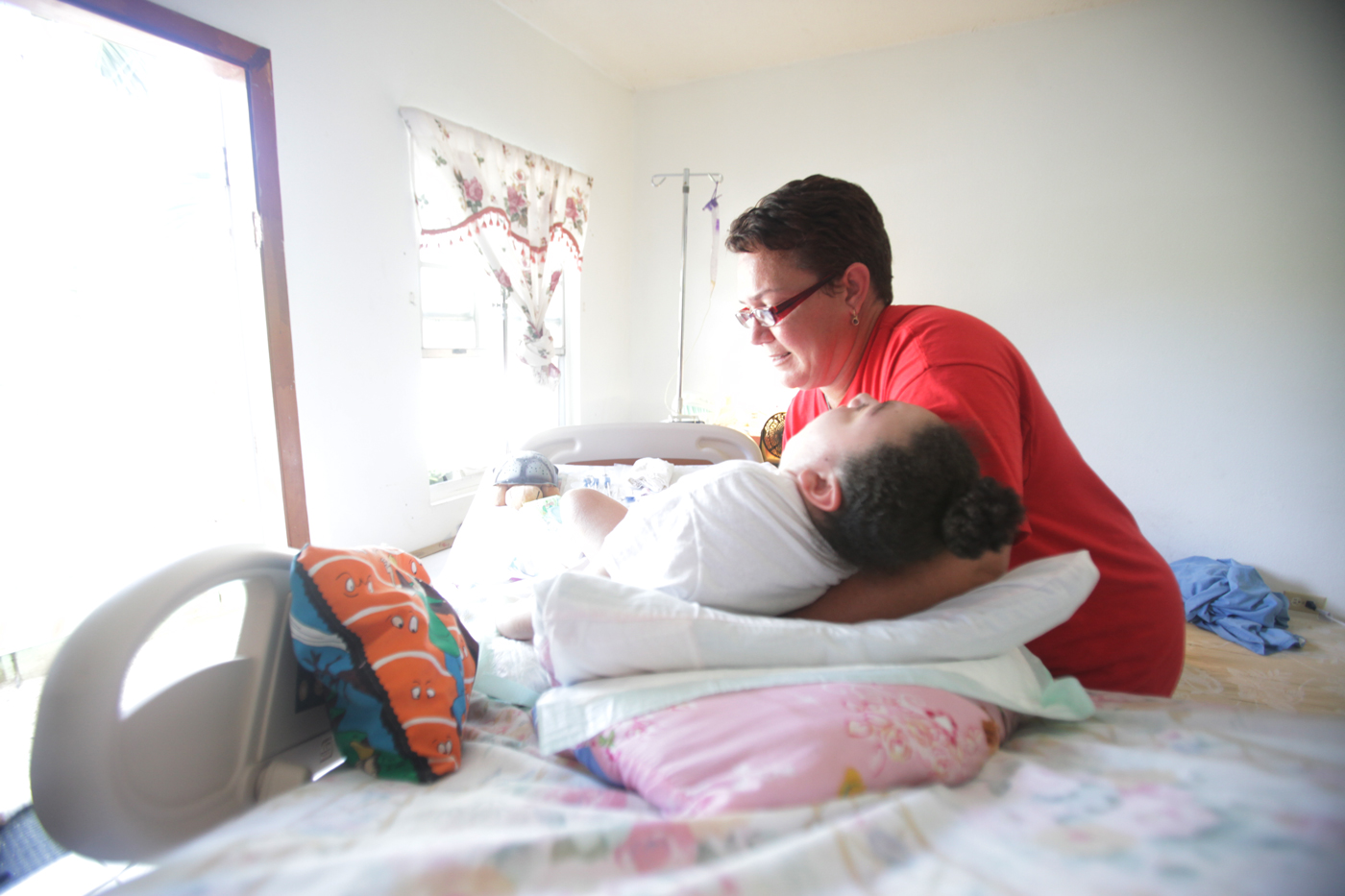 Norene Ebanks cares for her 10-year-old daughter Donette Thompson, who has cerebral palsy. - PHOTO: MATT LAMERS