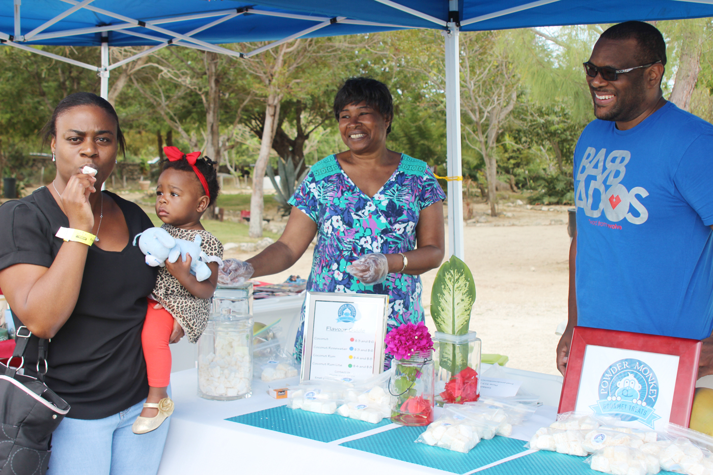 Lashawn Davis Barnett and Breanna sample coconut marshmallow as Power Monkey sellers Linda Kellman and Mark Ray give their approval.