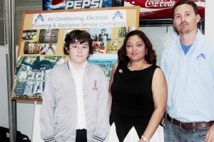 Student Callum Shields with Androgroup Ltd.'s business operations manager Annisa Ramdeen-Wood and CEO Steven Walsh