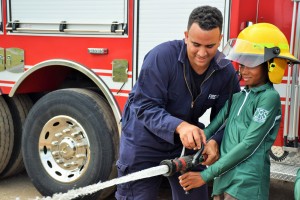 John Ebanks shows Michael Smith how to work the hose.