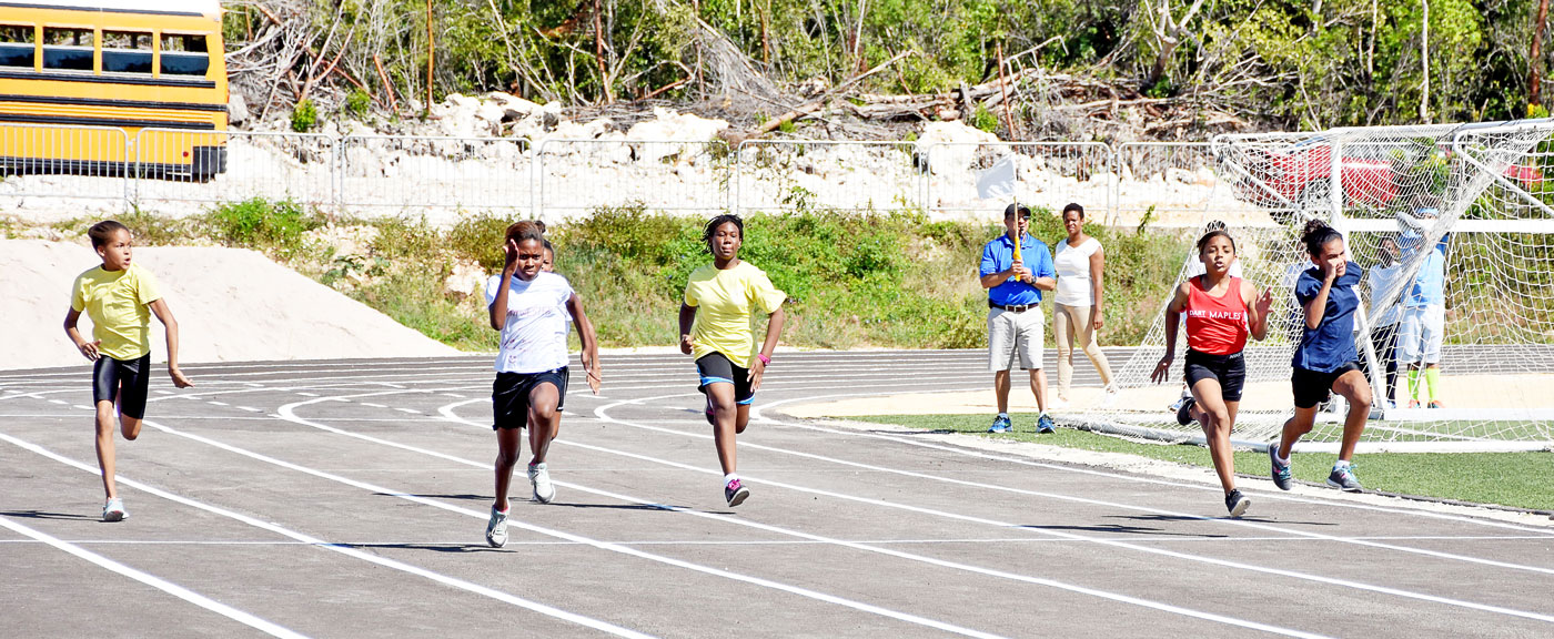 Junior girls compete in the 100m.