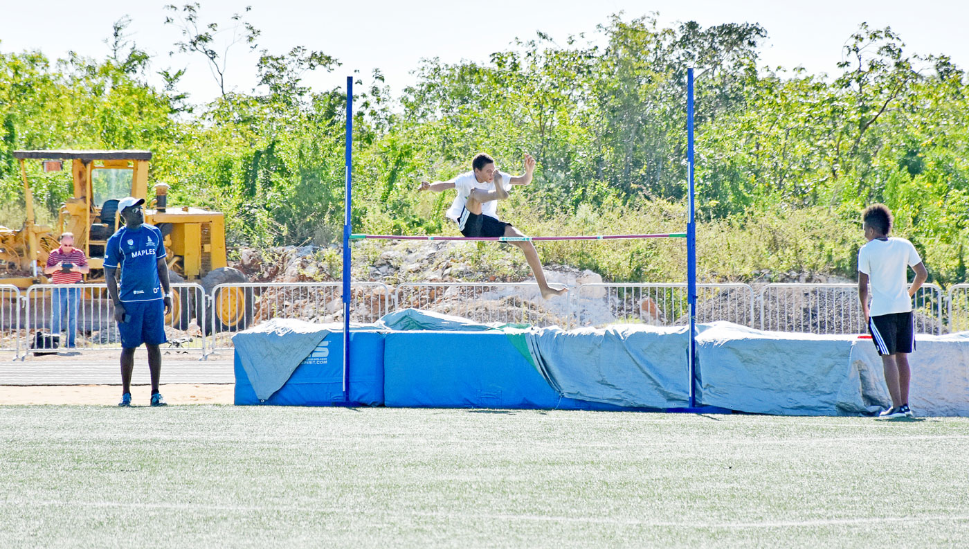 Senior boys compete in the high jump.