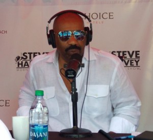 Steve Harvey at the mic as he hosts his radio show Thursday from the Comfort Suites on Seven Mile Beach. - PHOTO: JAMES WHITTAKER