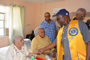 Stella Welcome greets Trevor Watler, John Ebanks and Michael Troop of the Lions Club of Grand Cayman.