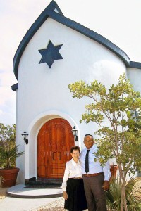 George Walton and his wife Lynne outside the temple they built on Cayman Brac.