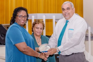 Annie-Rose Scott receives an award from Minister Osbourne Bodden.