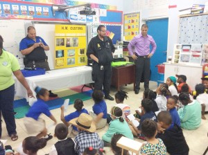 Students listen attentively to a presentation from customs officers.