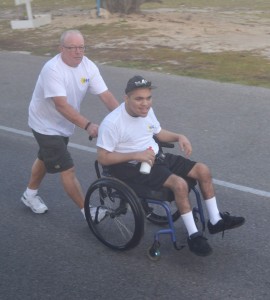 Leo St. Pierre pushes Jamaree Douglas in last year’s Walk With Harmony walkathon.