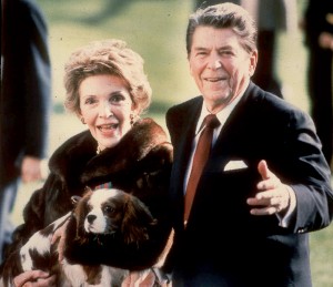 FILE - This December 1986, file photo shows first lady Nancy Reagan holding the Reagans' pet Rex, a King Charles spaniel, as she and President Reagan walk on the White House South lawn. The former first lady has died at 94, The Associated Press confirmed Sunday, March 6, 2016. (AP Photo/Dennis Cook, File)