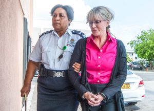 Police officers escort Michelle Bouchard to court to hear her sentence after a jury found her guilty on 25 counts. - PHOTO: TANEOS RAMSAY