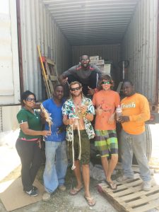 From left, Xiomara Lopez, Robert Welcome, Mike Vallee, Ed Houlcroft and Kirk Cunningham, and in back, Jermaine Spaulding, with the two iguanas that hitched a ride in a container shipped from Grand Cayman. - Photo: Lara Pullan