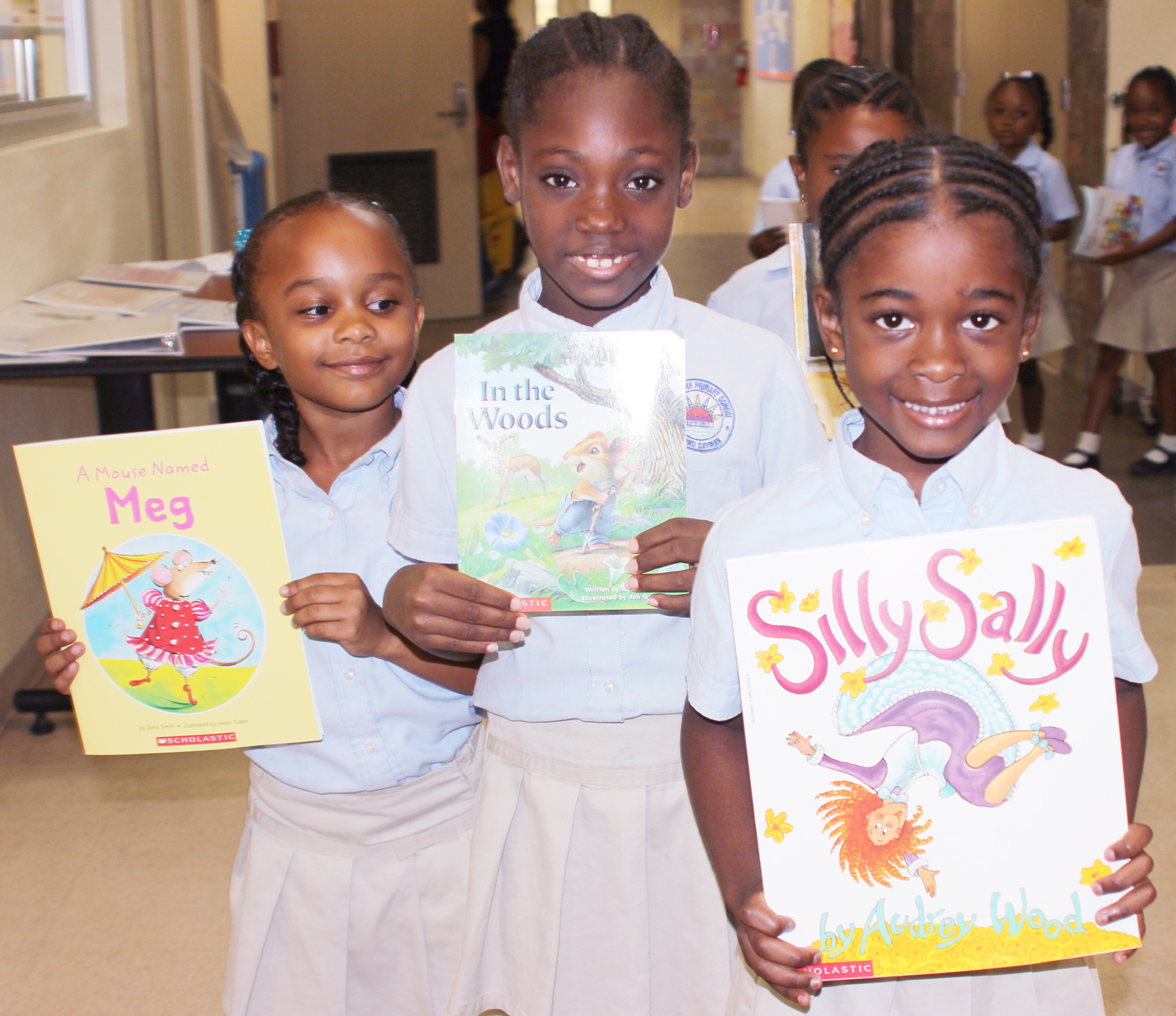 Year 1 students Jada Dixon-Lam, Kelsea Blake and Alexanjrea Bailey show off the books they chose.