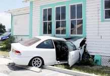 Teenager arrested after driving car into house