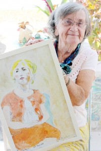 Maureen Andersen holds a painting of ‘Svetlana,’ which she completed in 2009.