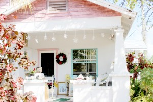 Ms. Andersen sits on her porch with her paintings. - Photos: Jewel Levy