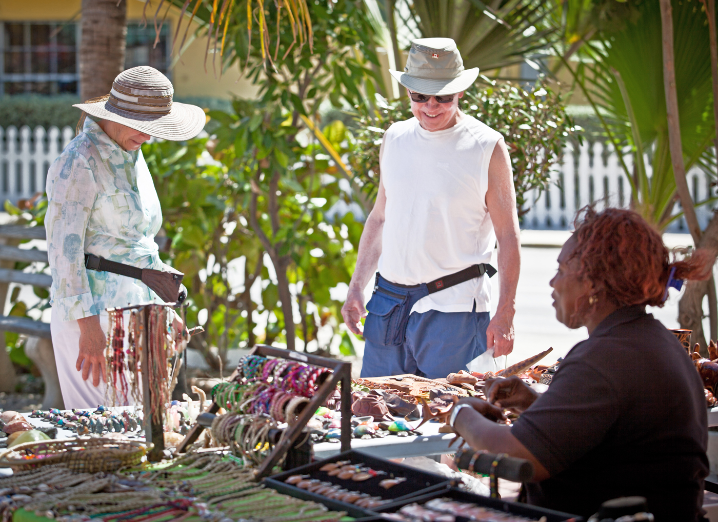 Tourists browse at a local craft stand. 