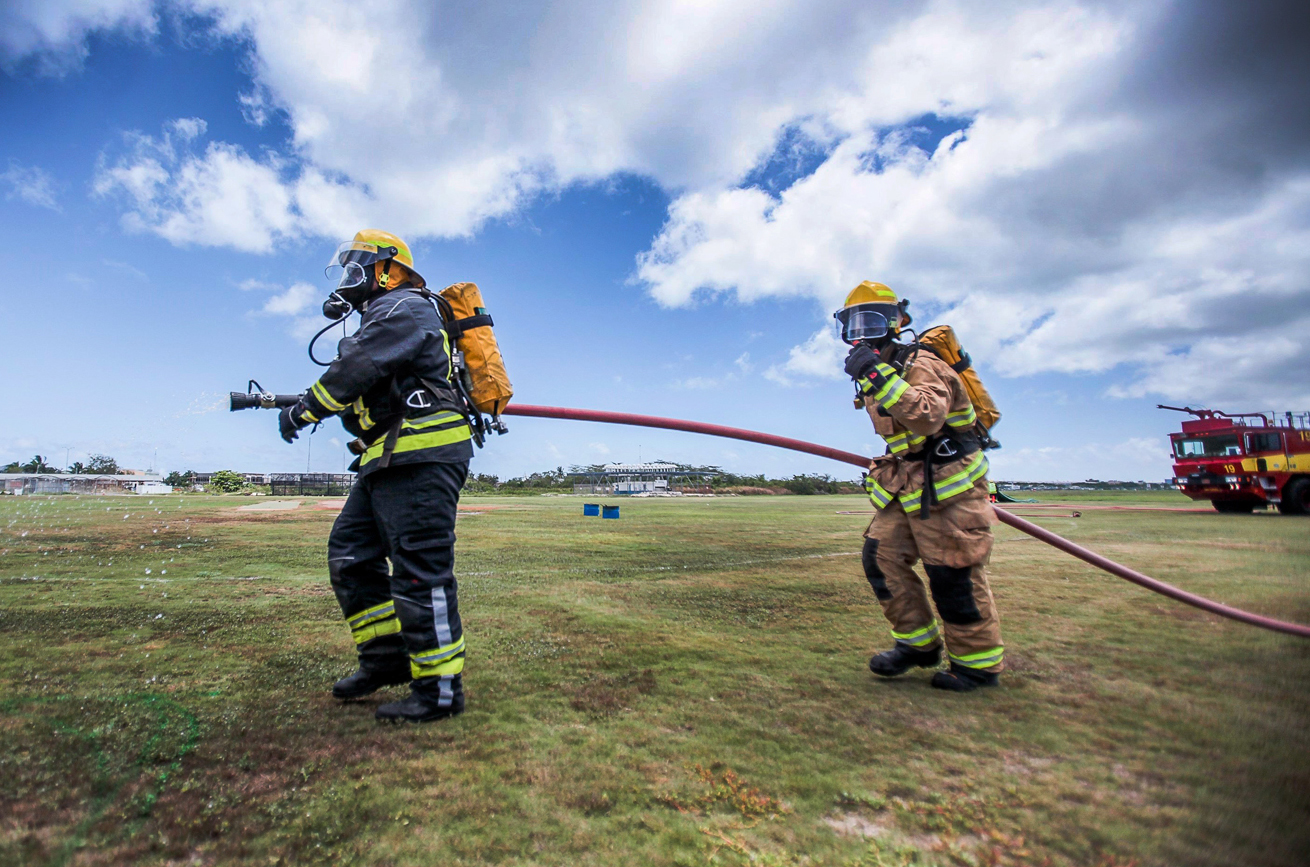 Firefighters battle a staged fire. 