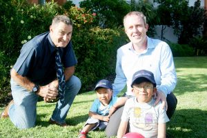 Derek Haines, left, and past president of the Rotary Club of Grand Cayman Brian Hurley with two Bolivian boys, Abdael and Carlos relax after a kickabout with a football after the children had recovered from surgery they had recently undergone.