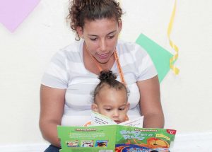 Alejahdro Kerr and mum Merranda enjoy the book 'Bug In A Rug.'