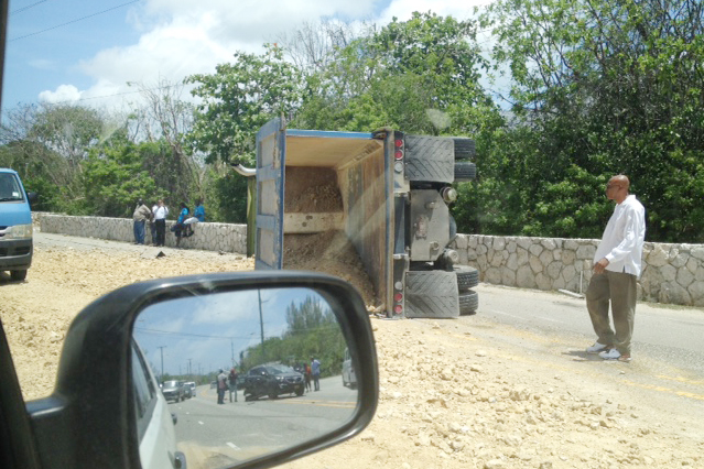 This picture, taken from a car along Shamrock Road, shows a tipped over dump truck. The SUV involved in the crash can be seen in the rear view mirror. Photos: Sonita Malan