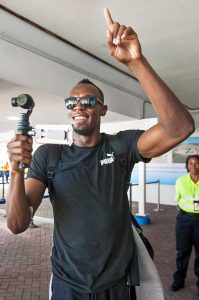 Usain Bolt captures some footage of his arrival in Grand Cayman Thursday afternoon. – PHOTO: TANEOS RAMSAY