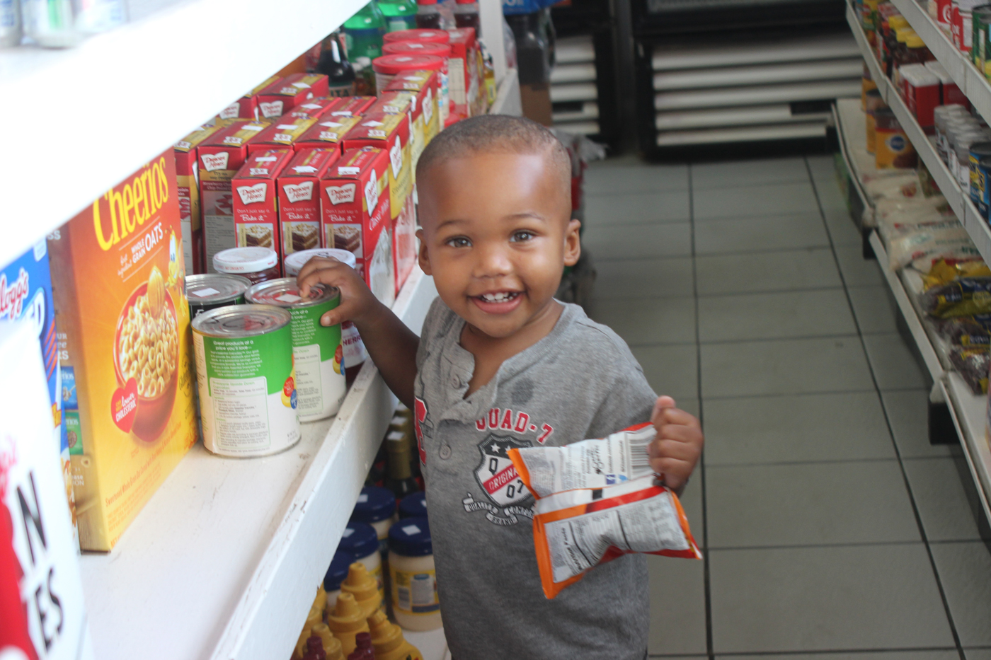 Young Xavier Welcome selects his purchase at the gas station.