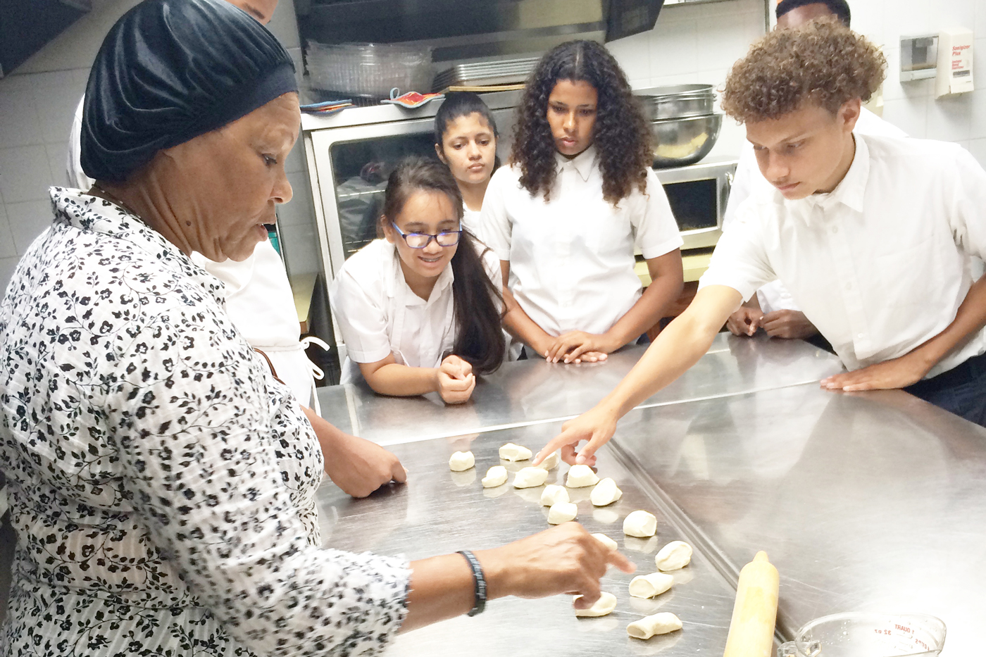 Greta Tatum leads a class for Layman E. Scott High School students on traditional preparation of whelks.