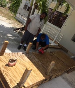 Sunrise Adult Training Centre client John White , in light grey shirt and staff member Diego Kelly work on building the dock prop.