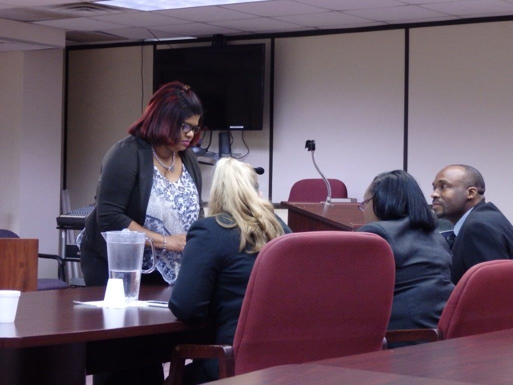 Drug court coordinator Katrina Watler, standing, consults with some team members. Seated, from left, are Erica Ebanks, a probation officer who has been reasssigned but attended anyway; Maxine Anglin, the only remaining probation officer; and Alfred McLeod, counselor. – PHOTO: CAROL WINKER