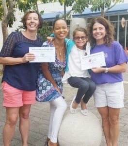 Lesley Agostinelli of CARE and Stacey VanDevelde of Feed Our Future with Stephanie Espeut and her daugher Alianna McClure.