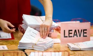 A teller counts ballot papers at the Titanic Exhibition Centre in Belfast, Northern Ireland, after polls closed in the EU referendum Thursday. - Photo: AP