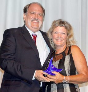 Sunset House’s Keith Sahm presents the water sports employee of the year award to Lois Hatcher.