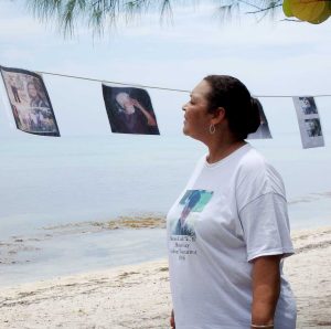 Burnis's niece Denise Ebanks looks at the family photo clothesline set up at the event.