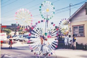 A reveler makes her way down the street surrounded by stars.