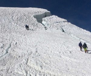 Derek Haines and a mountain guide, top left, approach the summit.