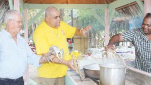 At last year’s crab fest, Bodden Town MLA’s Osbourne Bodden and Al Suckoo place the crabs in boiling water.