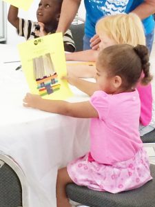 Kids craft wattle and daub houses at the day care.