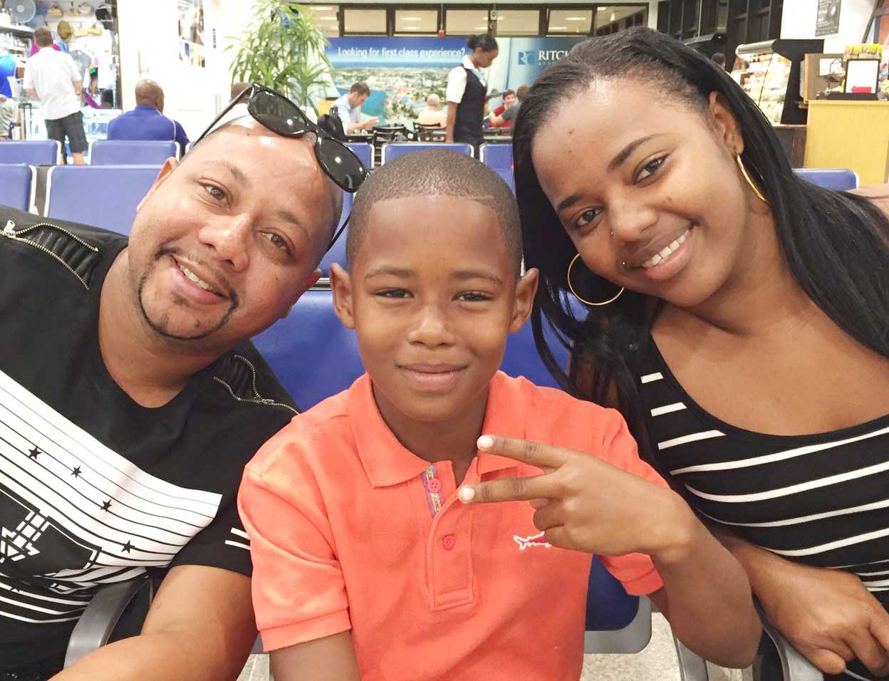 Shakur Connor gets ready to board his flight to Jamaica with his parents Angello Connor and Sonya Jervis.